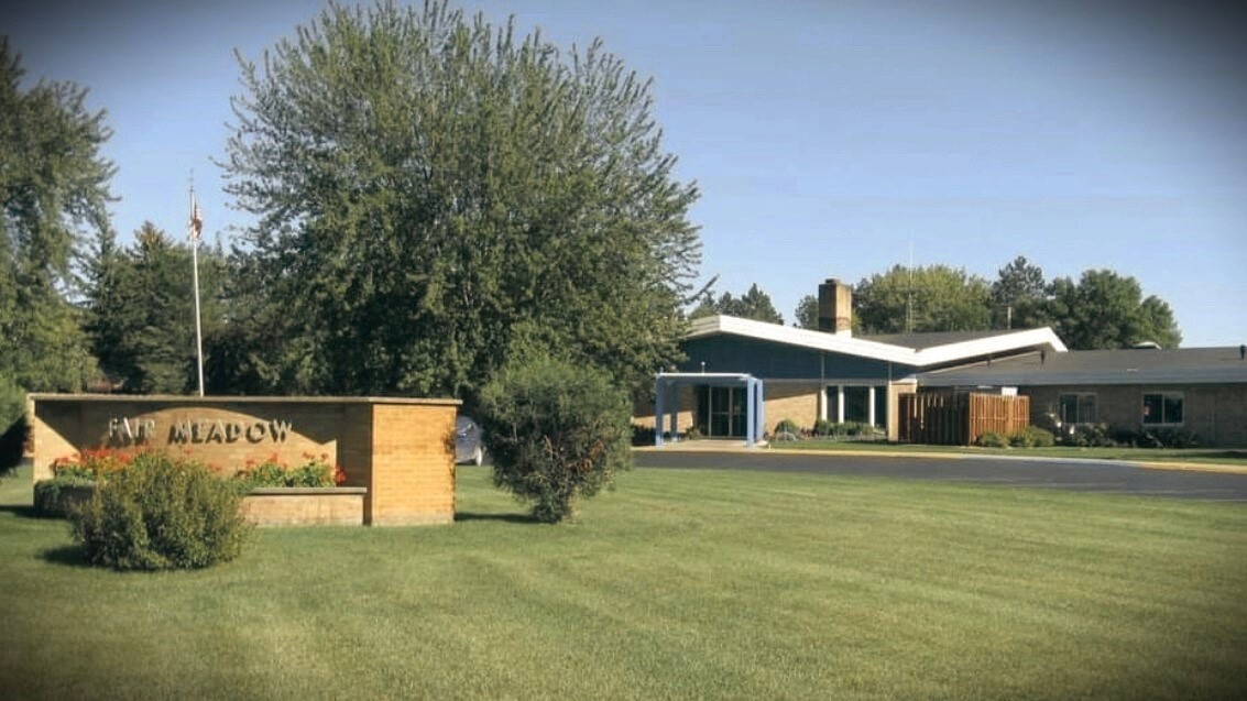 Photo of the outside of Fair Meadow Nursing Home on a sunny day