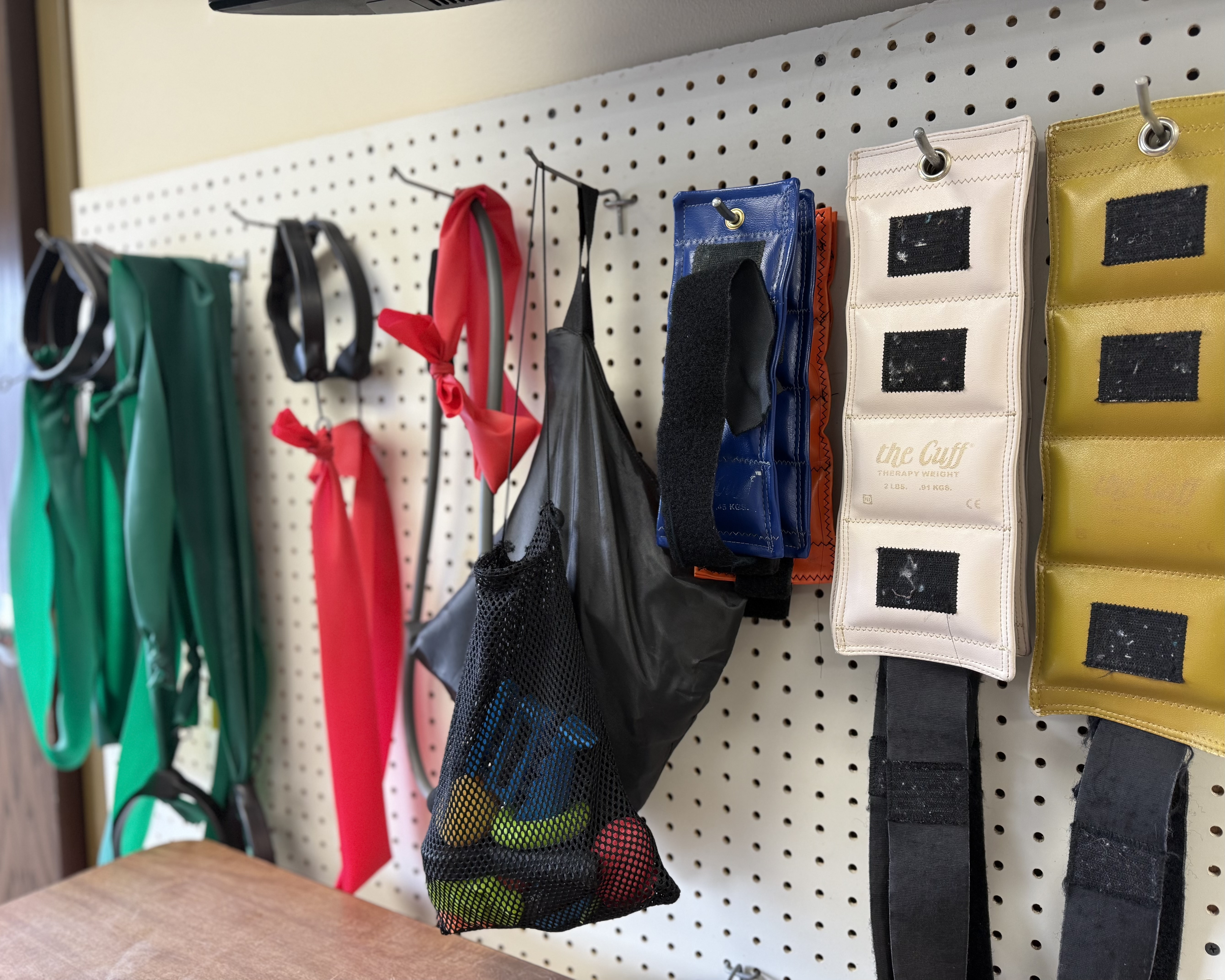 Photo of different excersie materials hanging on a wall
