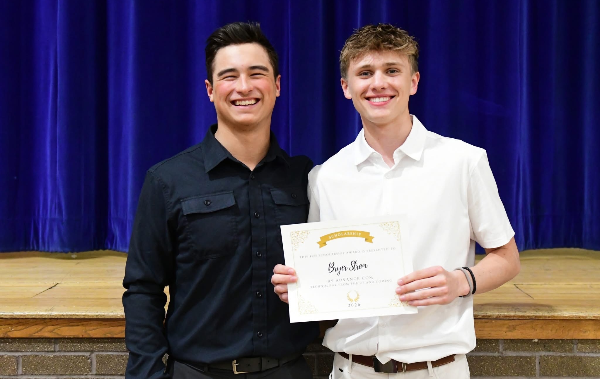 Two students recieving a scholarship